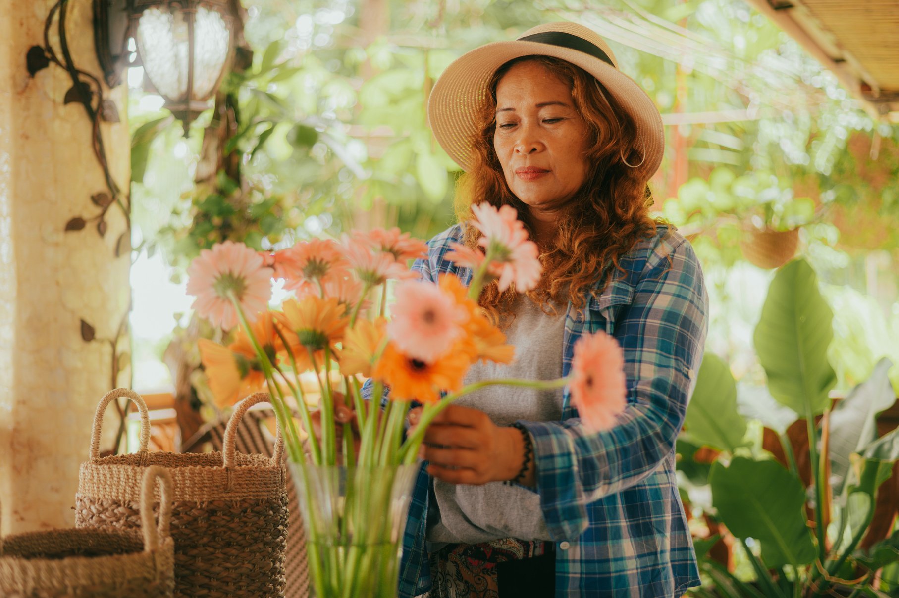 Woman Arranging Flowers in Vase